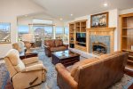 The large open layout is perfect for entertaining friends and family. This inviting living room has comfortable seating, amazing views and a fireplace.